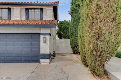 View of home's exterior with a tiled roof, a gate, and stucco siding