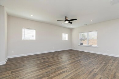 Empty room featuring dark wood-style floors, recessed lighting, and ceiling fan