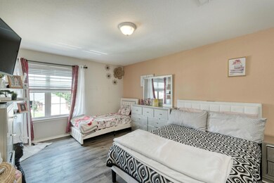Bedroom featuring wood finished floors and basebo