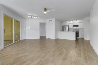 Unfurnished living room with baseboards, light woo