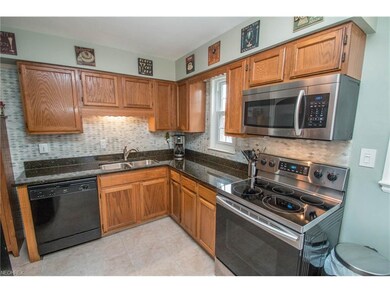 Updated kitchen with tile backsplash and granite counters