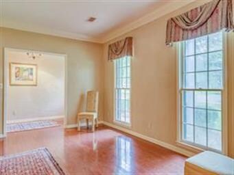 Hardwood floors, chandelier & double windows give 