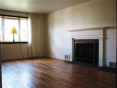 Living Room. Exposed hardwood floor and log burnin
