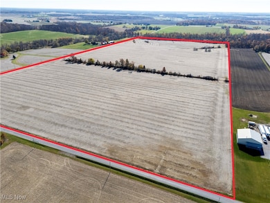 Aerial view of sparsely populated area with property boundaries highlighted and large plots for crops