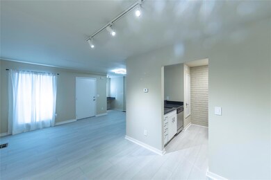 Empty room with light wood-style flooring, visible