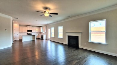 Unfurnished living room featuring visible vents, d