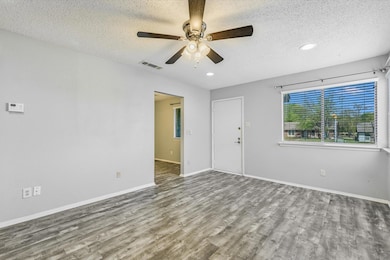 Unfurnished living room featuring wood finished f