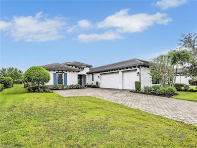 Prairie-style home featuring an attached garage, stucco siding, and a front yard