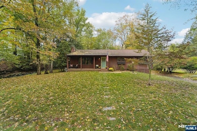 TUCKED ON OVER HALF AN ACRE OF PARKLIKE PROPERTY