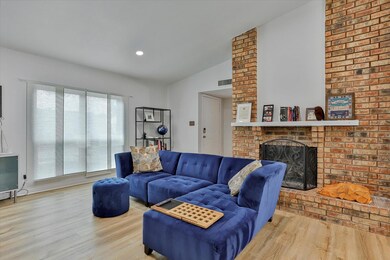 Living room featuring a fireplace, vaulted ceiling