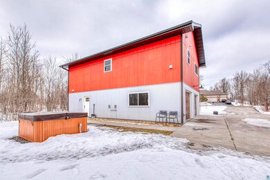 Snow covered house featuring a detached garage and