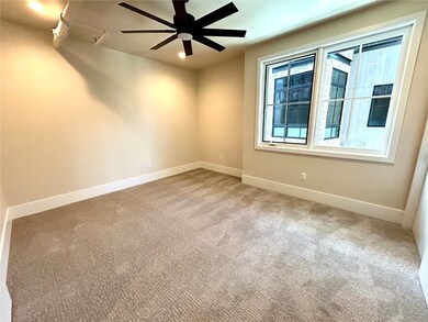 Spare room featuring ceiling fan and carpet floors