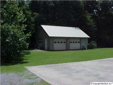 DETACHED GARAGE HAS POWER AND A HALF BATH. 3RD GARAGE DOOR ON SIDE OF BLDG.