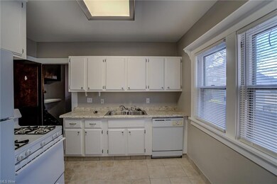 Downstairs apartment kitchen includes all appliances, freshly painted cabinets, new countertops and tile floor