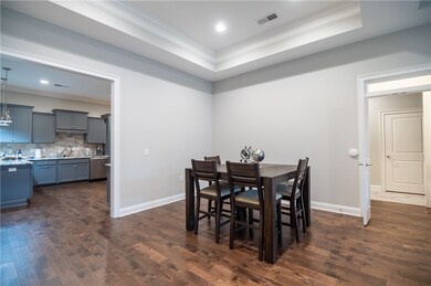 dining area; hallway to right leads to primary sui