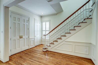 Double doors open to a welcoming entry that embrac