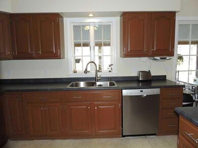 Kitchen. Rich dark cabinets with...