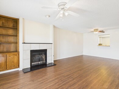Unfurnished living room with a textured ceiling, c