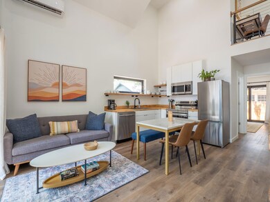 Living room with a towering ceiling, a wall mount