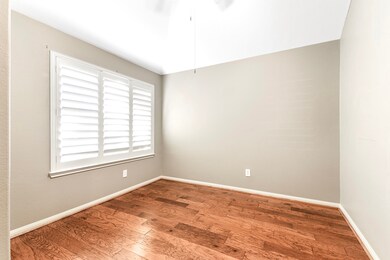 The den features beautiful wood flooring, plantation shutters, and a high ceiling with a ceiling fan. With its lovely front yard views, it’s an ideal space for a home office, playroom, or secondary sitting room.