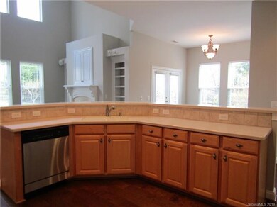 Kitchen with bar seating and open to the living ro