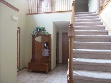 The inviting entry with tile floor and stylish sta