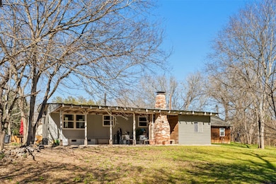 Rear view of property with crawl space, a yard, a