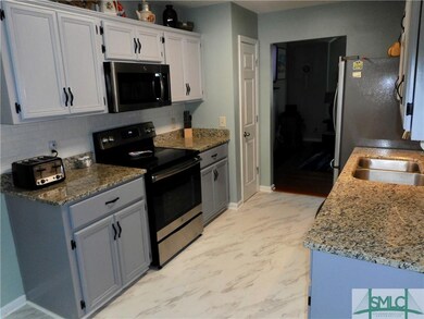 Kitchen with new microwave, stove and flooring
