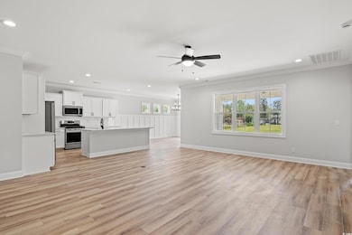 Unfurnished living room featuring light hardwood /