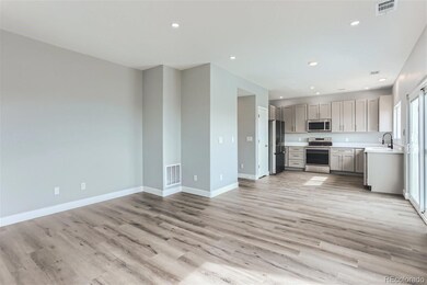 Family room looking onto eating space and kitchen