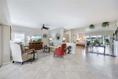 Living room featuring ceiling fan and baseboards