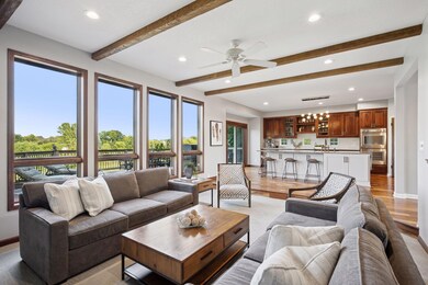 Rich cherry cabinetry, beamed ceilings, acacia walnut flooring and walls of windows with sweeping views showcase this beautiful country estate.