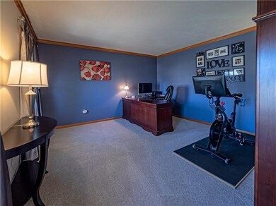 The family room boasts bright windows, plush carpe