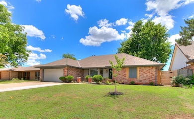 Single story home with brick siding, a garage, concrete driveway, and a shingled roof
