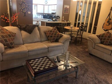 View of the living room, breakfast bar into kitche