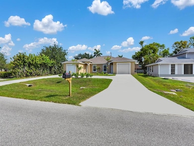 Ranch-style house with concrete driveway, a front lawn, and a garage