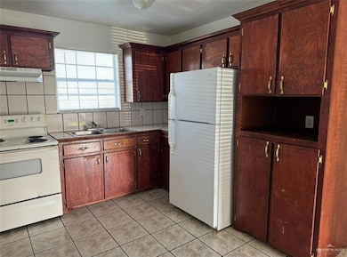 Entrance to property featuring brick siding