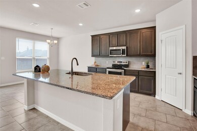 As you leave the hallway, you are greeted by this warm kitchen and dining room combination.  A large corner pantry is on the right.