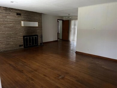Unfurnished living room with a fireplace and dark 