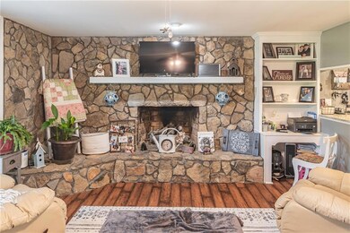Living area featuring wood finished floors and a fireplace