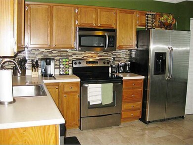 Kitchen. Stainless steel appliances, glass tile ba