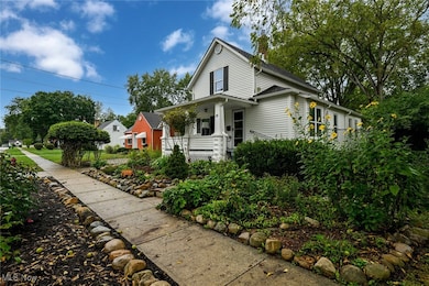 View of front facade featuring covered porch, landscaping