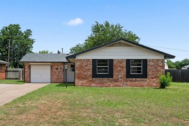 Single story home featuring a front lawn and a gar