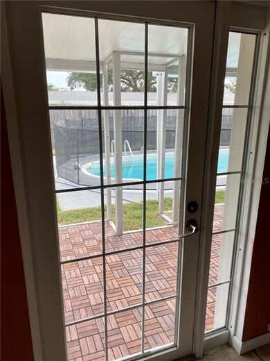 New French door to the porch and pool from the Liv