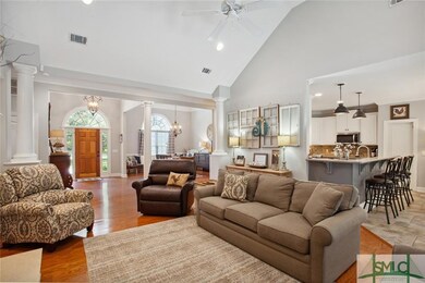 Step inside the soaring foyer and notice the hardw