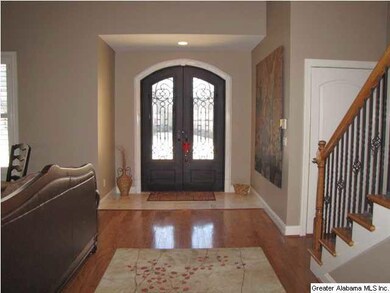 New double iron door and marble tile in the entry.