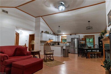 Living room featuring vaulted ceiling, a high ceil