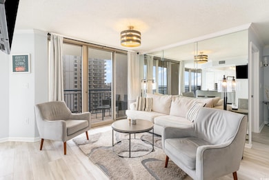 Living area, floor to ceiling windows, crown molding, and a textured ceiling