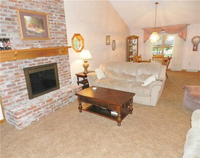 Vaulted ceiling living room with a floor to ceilin