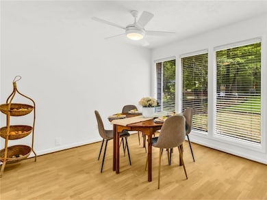 Dining room with light wood-style floors, baseboar